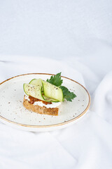 Vegan sandwich with cucumber and sun-dried tomato paste