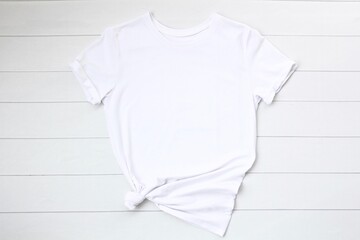 White t shirt on a white wood background. White tshirt mock up