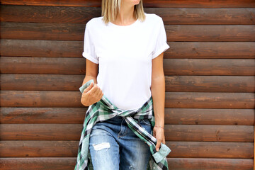 White tshirt mockup. Girl white t shirt template. Woman poses in wood background.