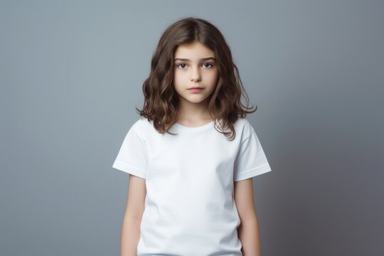 Portrait of a fictional young little girl wearing a plain white t-shirt. Isolated on a plain neutral background. Generative AI.