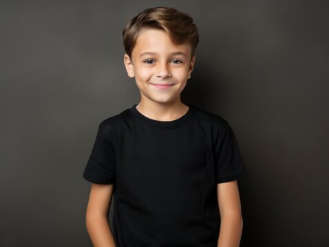 Portrait of a fictional young little boy wearing a plain black t-shirt. Isolated on a plain neutral background. Generative AI.