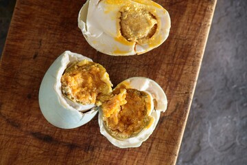 Exquisite Delicacy: 4K Close-Up of Salted Duck Boil Egg Resting on Wooden Surface