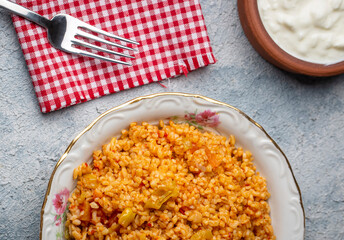 Traditional turkish bulgur pilaf with tomato sause in plate (Turkish name; meyhane pilavi)