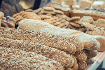 Freshly baked wholegrain baguette with grains in bakery