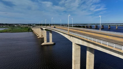 Fototapeten Aerial view of the Victory Bridge in Sayreville with cars traveling across the bridge © James Nesterwitz/Wirestock Creators