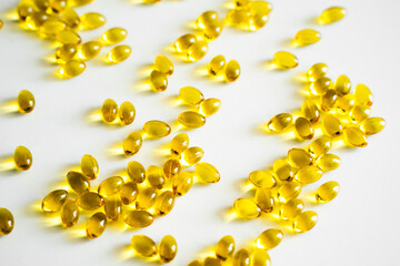 Oil filled capsules, softgel of food supplements. Vitamin D3. Yellow softgels, top view, copy space. Nutritional supplements.