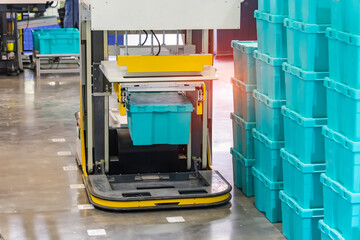 automatic warehouse robot car carries cardboard box assembly in factory