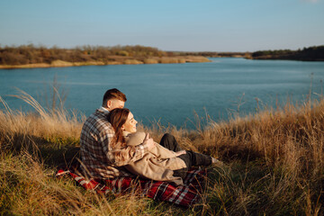 Happy couple walk and enjoy each other in sunny autumn park. Enjoying time together. Lifestyle. Style concept, autumn fashion.