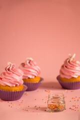 Variety of colorful cupcakes with various types of frosting