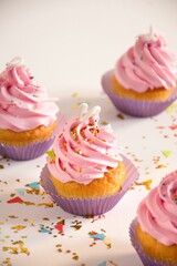 Variety of colorful cupcakes with various types of frosting