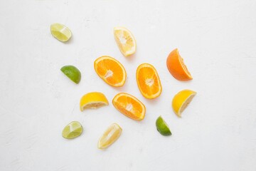 Top view of several citrus fruits arranged on a plain white background.