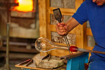 Glass Blower Shaping Molten Glass into a Piece of Art