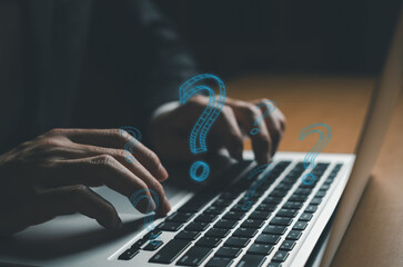 Selective focus at men hand while typing keyboard for asking question from online customer service...