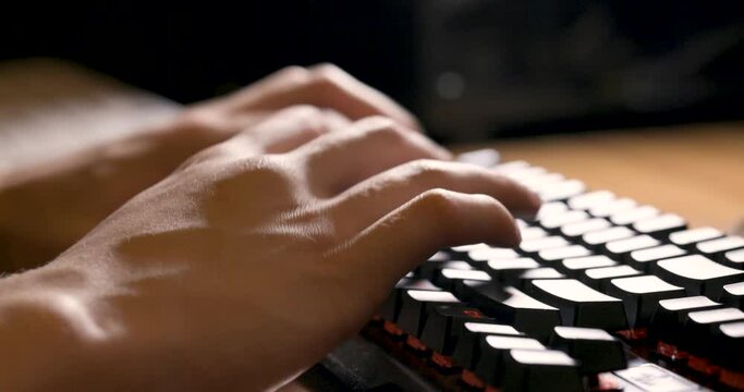 Male hand typing on the black keyboard, with keyboard sound