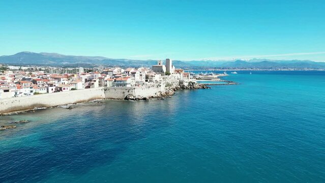 Aerial of the white buildings of Brindisi city in Italy alongside the blue sea