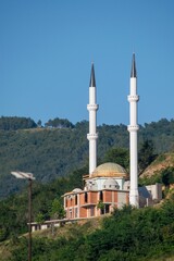Fototapeta na wymiar A beautiful isolated mosque with two tall minarets, built on a hill near the city of Prizren, Kosovo