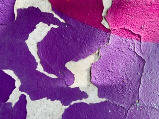 Vibrant purple wall with peeled-off paint.