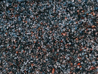 Top view of a pile of small pebbles arranged in an abstract pattern.