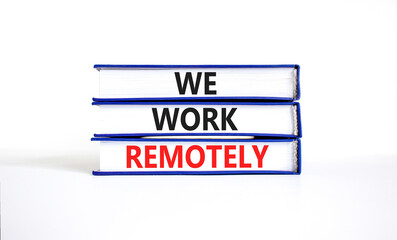 We work remotely symbol. Concept words We work remotely on beautiful book. Beautiful white table white background. Business we work remotely concept. Copy space.