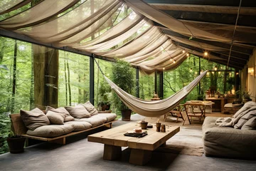 Foto op Plexiglas Ecolodge or eco-lodge house interior with green plants, adorned with hammocks and various greenery, creating a serene and relaxing ambiance, surrounded by the natural beauty © zakiroff