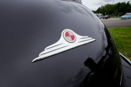 Eisenacher Motorenwerk - EMW (an East German Manufacturer Of Automobiles) Antique Car Emblem From The 1950s On A Car At A Exhibition In Bernau Bei Berlin - Germany 