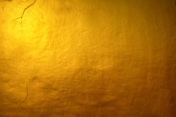 A solid gold texture. Shimmering orange gold background.