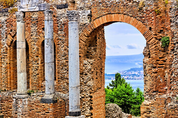 View through the arches and columns of the ancient Greek Theater of Taormina, Sicily, Italy
