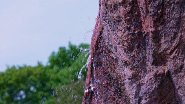 Rock with spring water slow motion at Rosetta McClain Gardens. Named in honour of community activist and environmentalist. Public garden located in Scarborough, eastern part of Toronto, Canada.