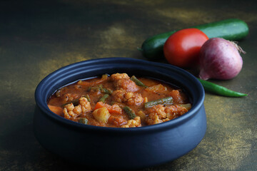 Mix vegetable curry - Indian main course recipe contains Carrots, cauliflower, green peas and beans, baby corn, capsicum and paneer/cottage cheese with traditional masala and curry, selective focus