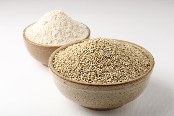 Bajra pearl millet  sorghum grains with it's flour or powder in a bowl, selective focus