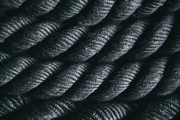 Close up of black battle rope for functional training. Sport and fitness equipment.