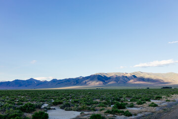 A beautiful landscape with big mountains at sunset. Blue clear sky above mountains on a sunny summer day at sunset