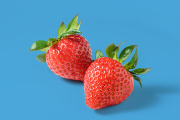 fresh appetizing strawberries on a blue background, studio shooting 1