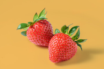 fresh appetizing strawberries on a yellow background, studio shooting 1
