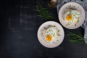 Croque madame with bechamel sauce. Freanch toasts with ham, cheese and fried egg