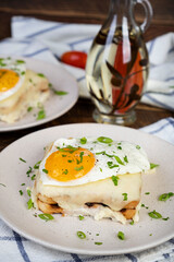 Croque madame with bechamel sauce. Freanch toasts with ham, cheese and fried egg