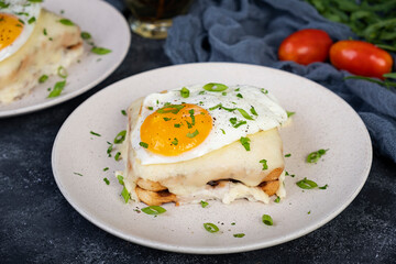 Croque madame with bechamel sauce. Freanch toasts with ham, cheese and fried egg