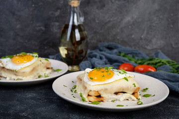 Croque madame with bechamel sauce. Freanch toasts with ham, cheese and fried egg