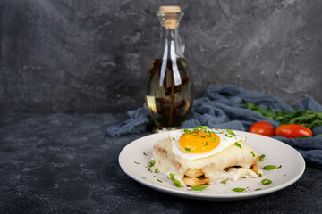 Croque madame with bechamel sauce. Freanch toasts with ham, cheese and fried egg