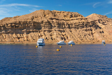 Yachts in sea port of Sharm El-Sheikh, rock mountain view, Egypt, South Sinai