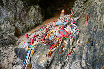 Wooden sculptures of phalluses of different colors in the Princess Cave, a buddhist temple on Phra Nang Cave Beach on the Railay Peninsula in the Province of Krabi, Thailand