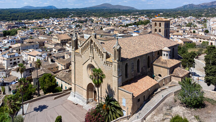 Fototapeta na wymiar Aerial view of the parish church of the Transfiguration of the Lord in the town of Artà on Majorca in the Balearic Islands, Spain