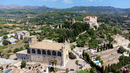 Fototapeta na wymiar Aerial view of the pilgrimage church of Sant Salvador surrounded by fortification walls on a hill overlooking the town of Artà on Majorca in the Balearic Islands, Spain