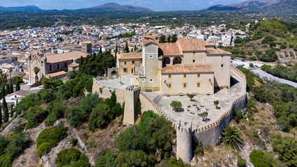Aerial view of the pilgrimage church of Sant Salvador surrounded by fortification walls on a hill...