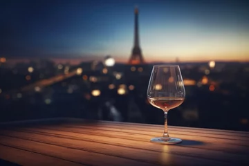 Selbstklebende Fototapeten Wooden table top with a glass of wine with a blurred paris in background © Julien