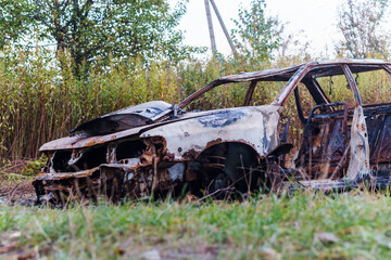 A burnt-out car. Fire burned car. Car old burned by fire.