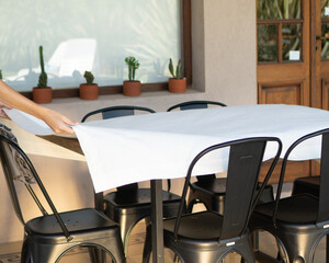 Setting the Table: Woman arranging with tablecloth, plates, and cutlery