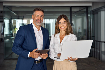 Two diverse partners, colleagues, team of confident professional business people work together....