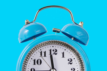 Retro Alarm Clock. Close up One Classic Alarm Clock on a Blue Background