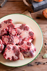 Beef Oxtail Meat on kitchen table with vegetables
